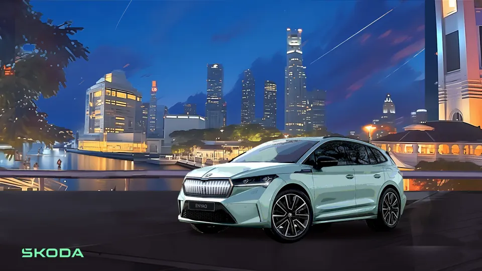 White Škoda car parked beside a waterfront city skyline